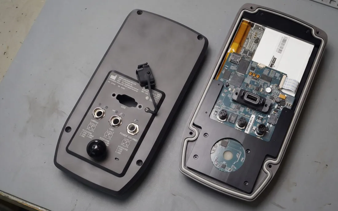 Custom handheld controller opened to show its circuit board